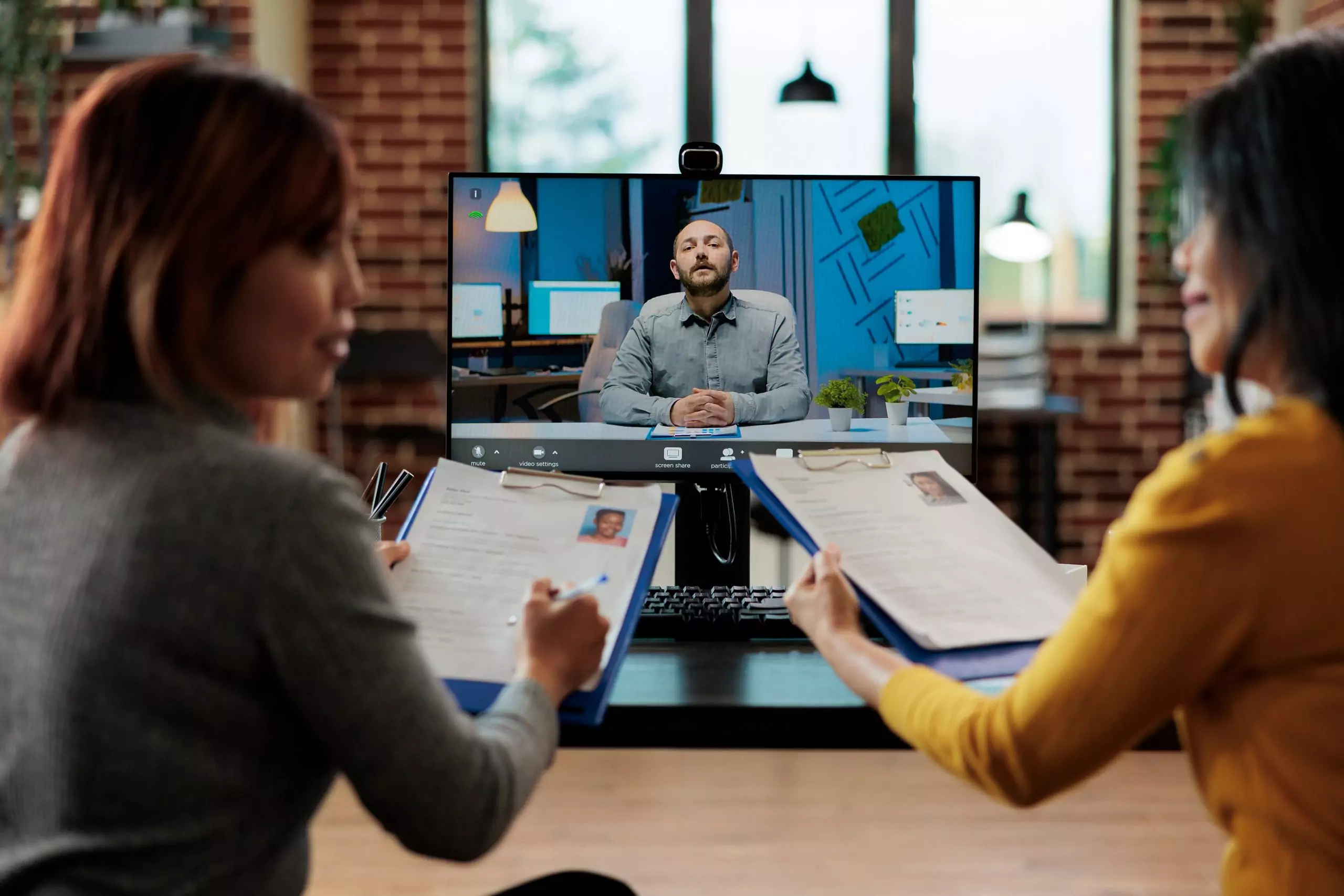 Interviewers discussing company hiring plan with applicant