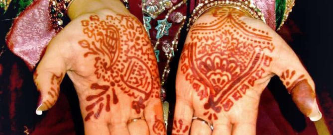 Decorative henna tattoos on an Indian woman's hands.