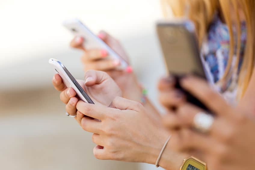 Live streaming engagement Multiple mobile phone users using their phones all at the same time.