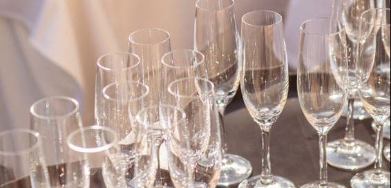 Champagne flutes on two silver trays.
